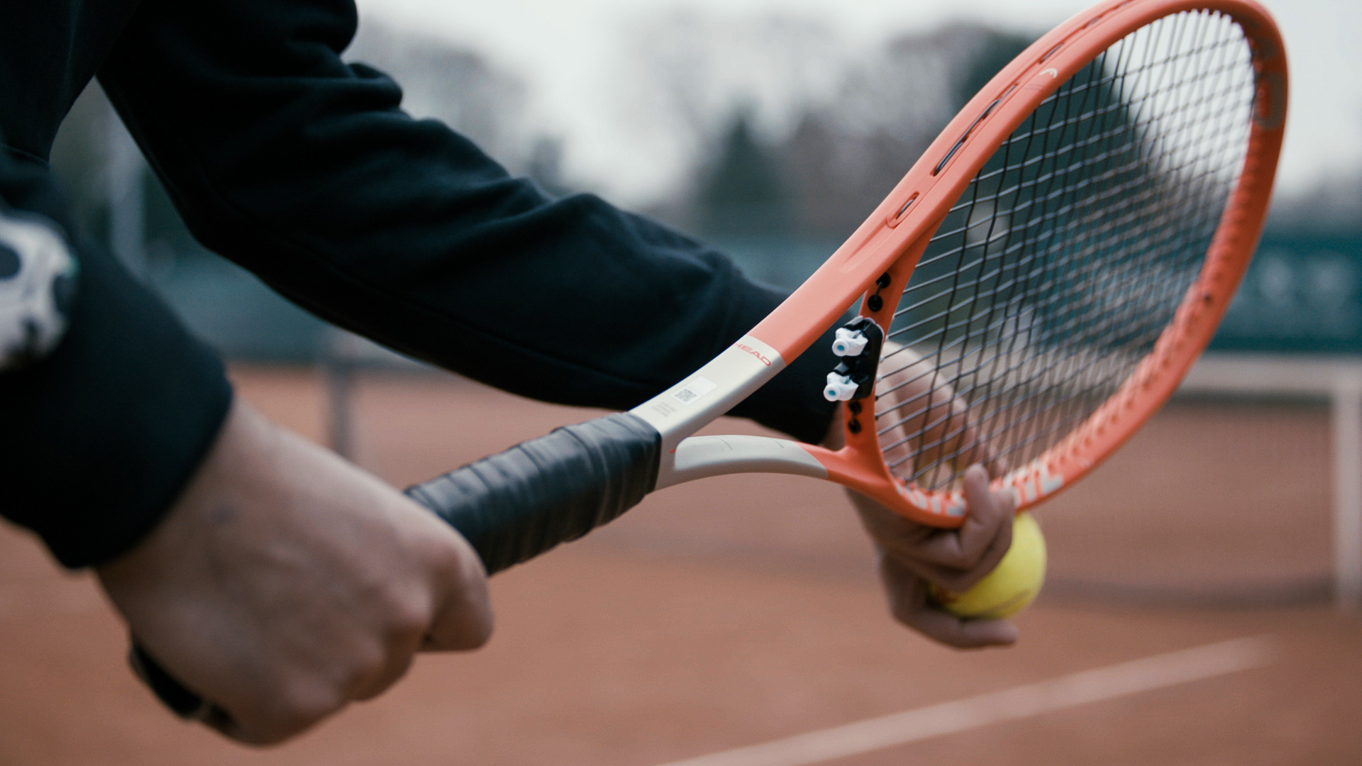 The Retenser fitted at the throat of a modern open-throated racquet